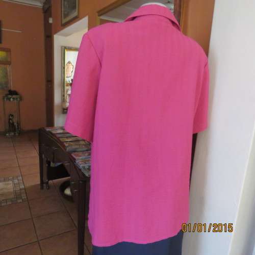 Top of the line magenta pink richly embroidered short sleeve bubble polyester top. Size 46. As new