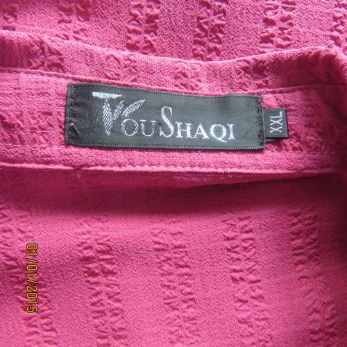 Top of the line magenta pink richly embroidered short sleeve bubble polyester top. Size 46. As new
