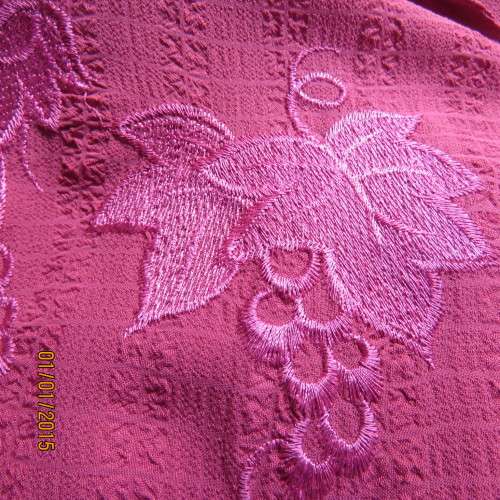 Top of the line magenta pink richly embroidered short sleeve bubble polyester top. Size 46. As new