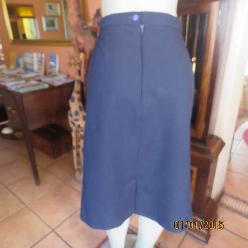 Elegant dark navy polyester pencil skirt. Upper calf length. Zip/pleat at back. Size 42 to 44.As new