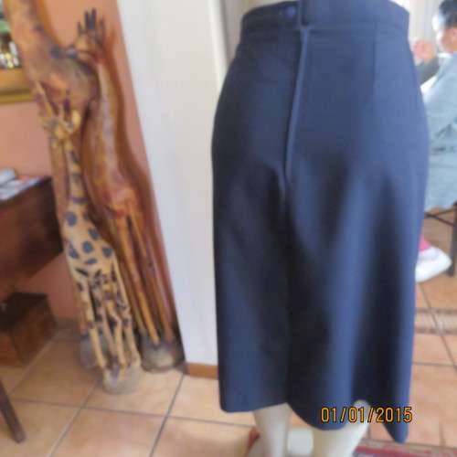 Elegant dark navy polyester pencil skirt. Upper calf length. Zip/pleat at back. Size 42 to 44.As new