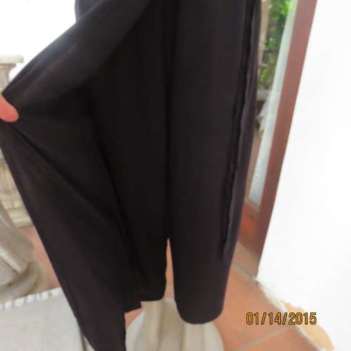 Elegant modern black jumpsuit with foldover skirt front. In 100% rayon.High collar.Size 38/14.As new