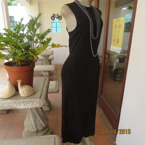 Elegant modern black jumpsuit with foldover skirt front. In 100% rayon.High collar.Size 38/14.As new