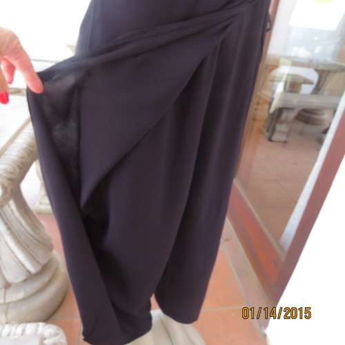 Elegant modern black jumpsuit with foldover skirt front. In 100% rayon.High collar.Size 38/14.As new