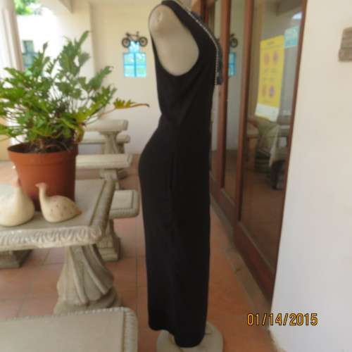 Elegant modern black jumpsuit with foldover skirt front. In 100% rayon.High collar.Size 38/14.As new