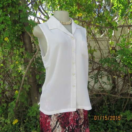 Cool sleeveless summer top in cream polyester. Pretty embroidery on collar and front.Size 36. As new