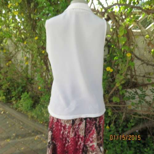 Cool sleeveless summer top in cream polyester. Pretty embroidery on collar and front.Size 36. As new