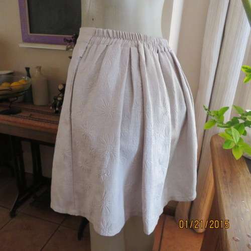 Charming light grey floral embossed poly/nylon knee length skirt.Size 36. Inverted front pleats.