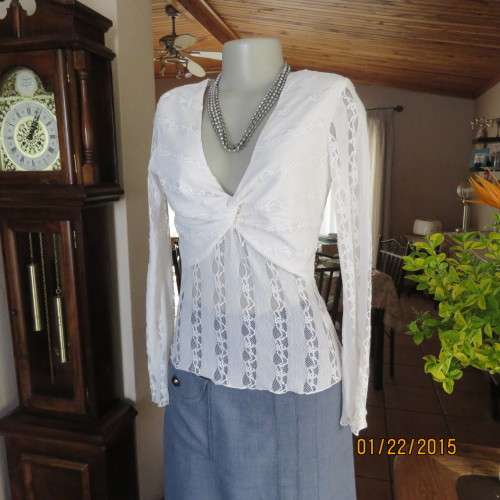 Attractive acrylic stretch lace pull over long sleeve cream top.Knot in center of lined bust.Size 37