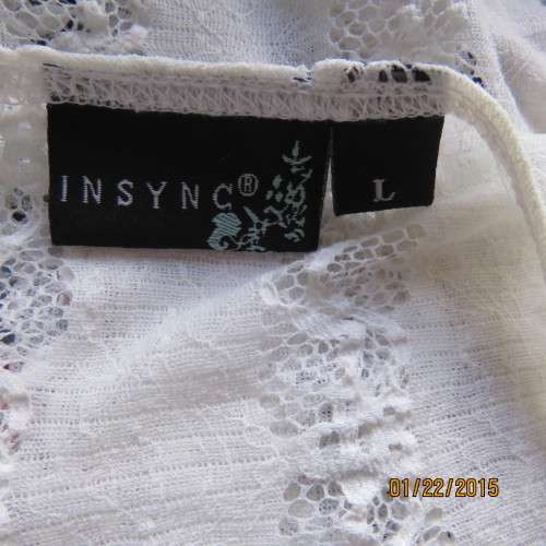 Attractive acrylic stretch lace pull over long sleeve cream top.Knot in center of lined bust.Size 37
