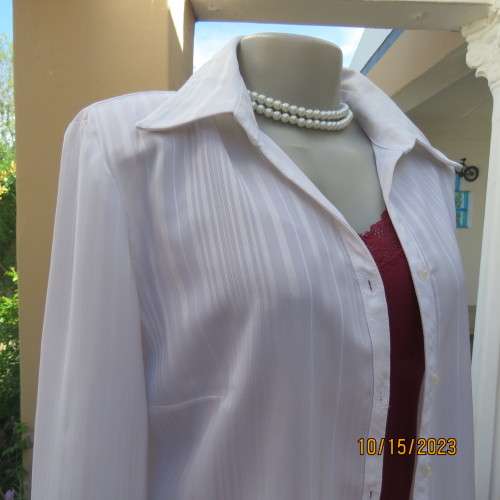 Smart white long sleeve polyester stretch top. Button down /open collar. Embossed stripes. Size 36.