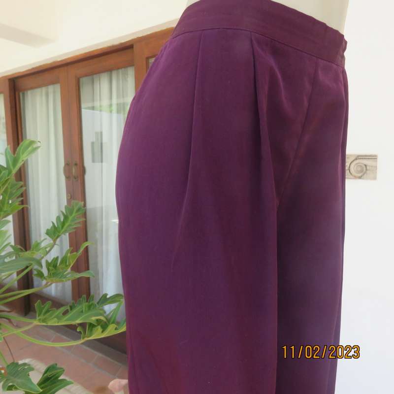 Smart but comfy dark purple satin look polyester pants. Pleated front/elasticated back.Size 40 to 42