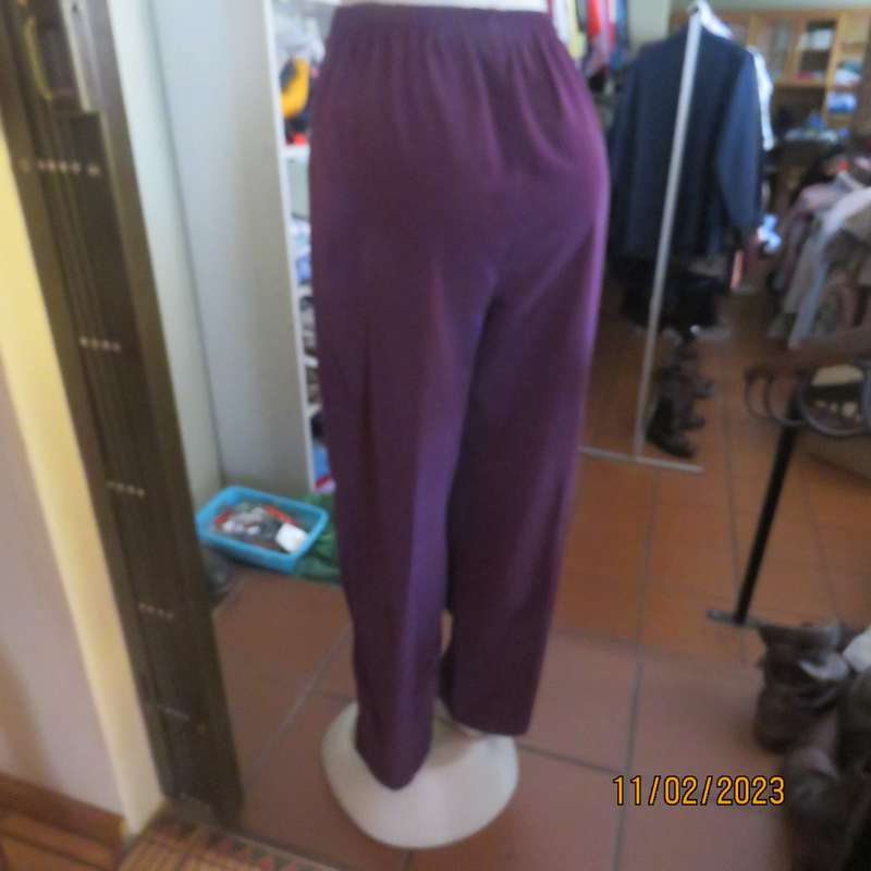 Smart but comfy dark purple satin look polyester pants. Pleated front/elasticated back.Size 40 to 42