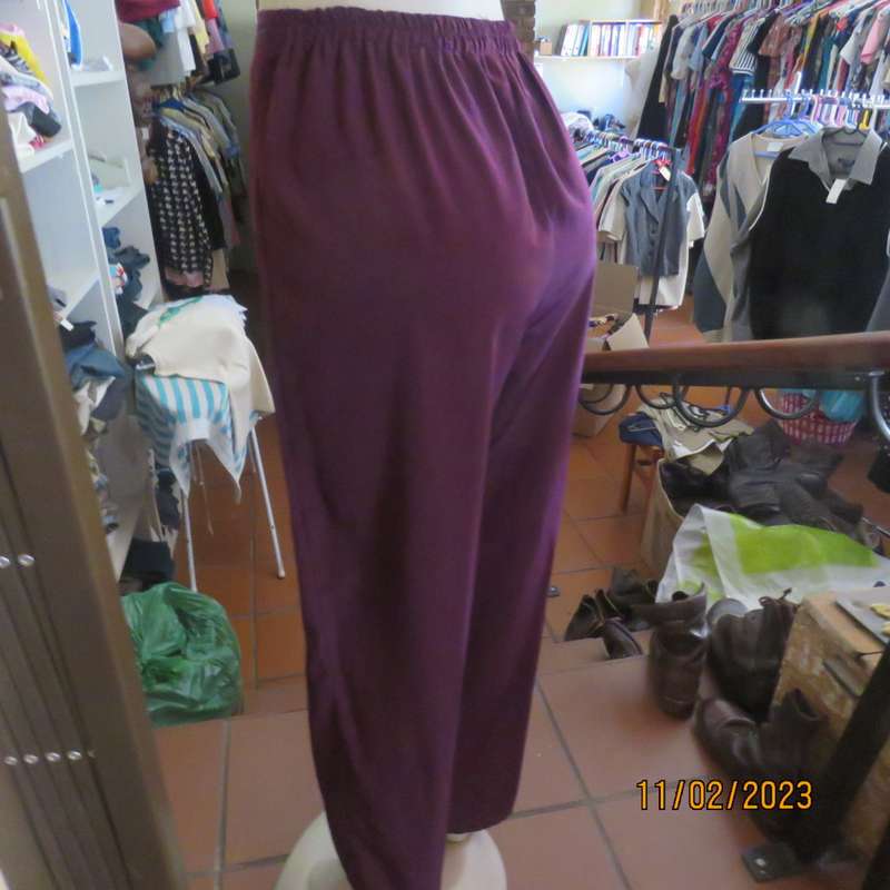 Smart but comfy dark purple satin look polyester pants. Pleated front/elasticated back.Size 40 to 42