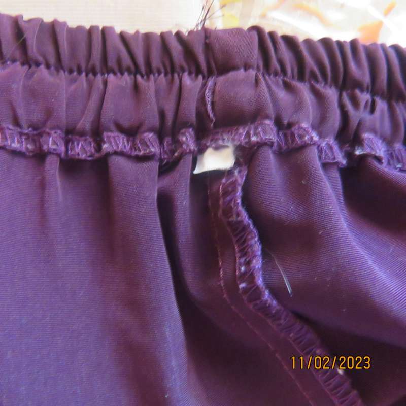 Smart but comfy dark purple satin look polyester pants. Pleated front/elasticated back.Size 40 to 42