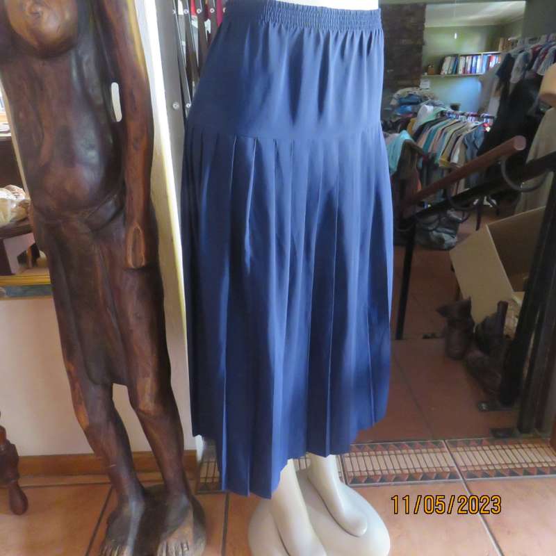 Ageless/easy to wear navy silky poly permanent pleated skirt. Wide yoke/elasticated waist.CAVIAR 36.