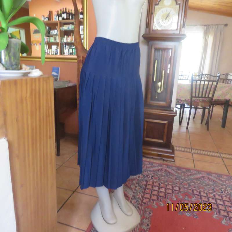 Ageless/easy to wear navy silky poly permanent pleated skirt. Wide yoke/elasticated waist.CAVIAR 36.