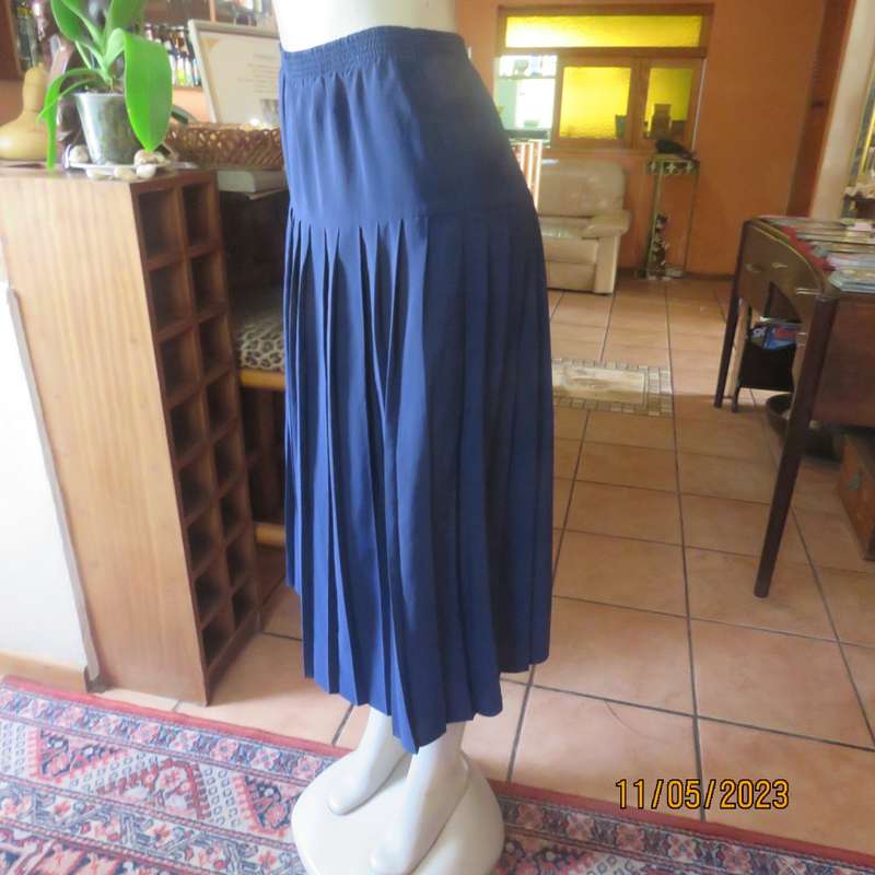 Ageless/easy to wear navy silky poly permanent pleated skirt. Wide yoke/elasticated waist.CAVIAR 36.