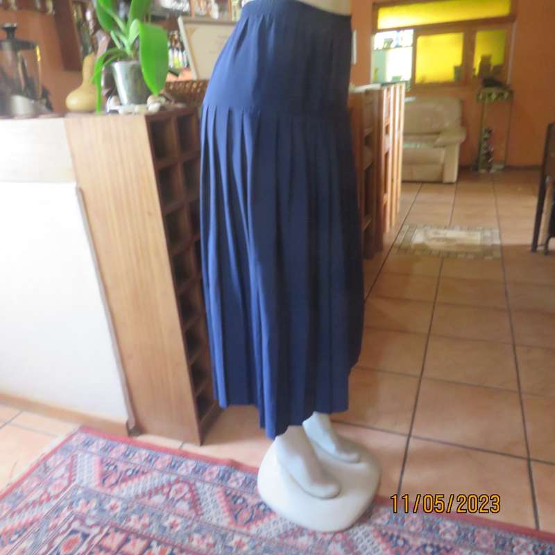 Ageless/easy to wear navy silky poly permanent pleated skirt. Wide yoke/elasticated waist.CAVIAR 36.