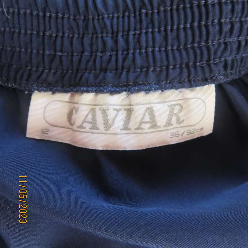 Ageless/easy to wear navy silky poly permanent pleated skirt. Wide yoke/elasticated waist.CAVIAR 36.