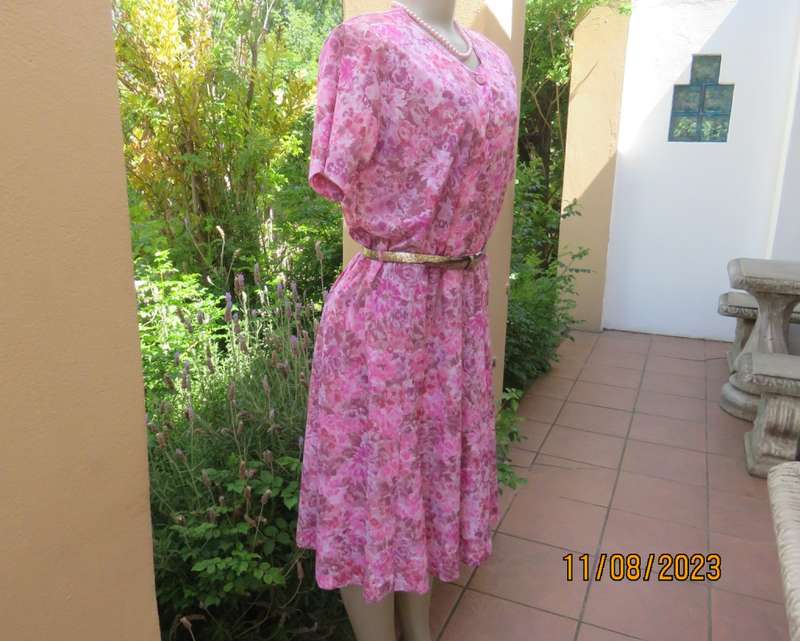 Beautiful textured silky poly dress with roses in pink shades. Size 40. Elasticated waist. As new.