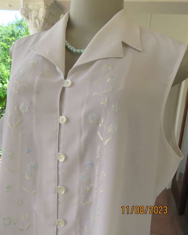 white sleeveless summer top with dainty blue/white embroidery. Size 42