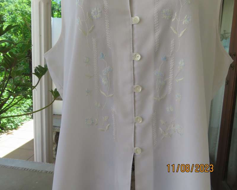 white sleeveless summer top with dainty blue/white embroidery. Size 42