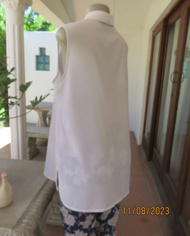 white sleeveless summer top with dainty blue/white embroidery. Size 42