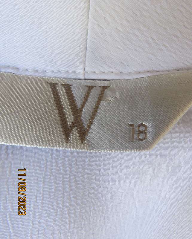 white sleeveless summer top with dainty blue/white embroidery. Size 42