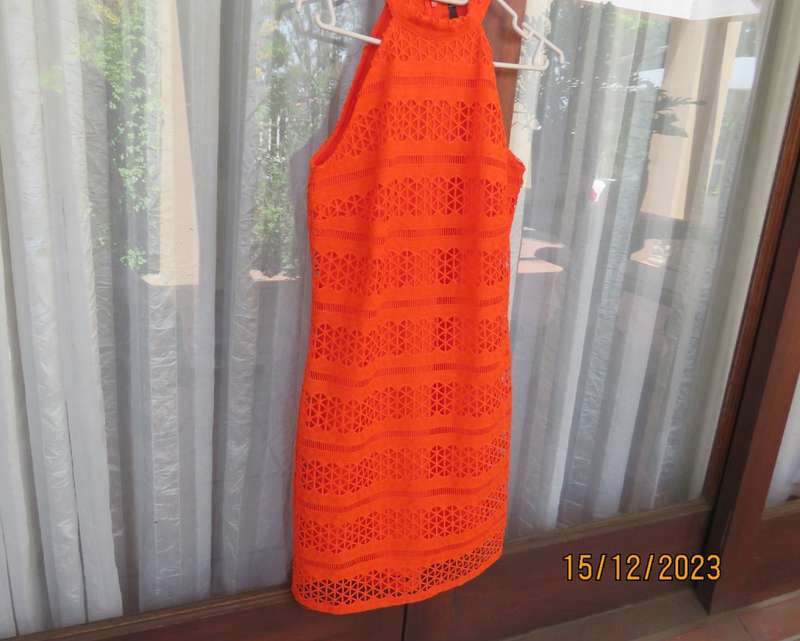 Outrageous orange sexy dress in heavy polyester lace/stretch poly lining. Size 30 by WOOLWORTHS.New