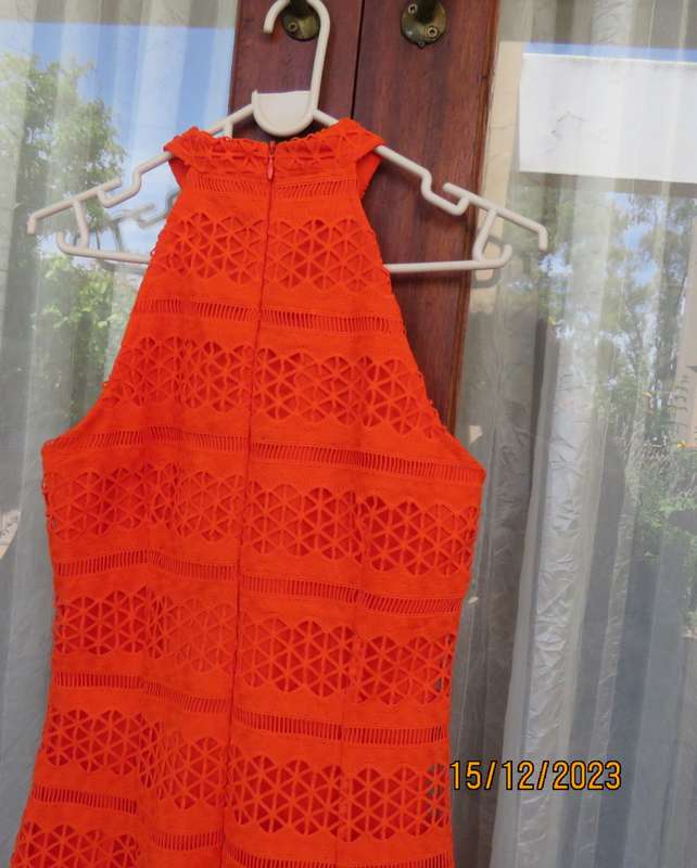 Outrageous orange sexy dress in heavy polyester lace/stretch poly lining. Size 30 by WOOLWORTHS.New