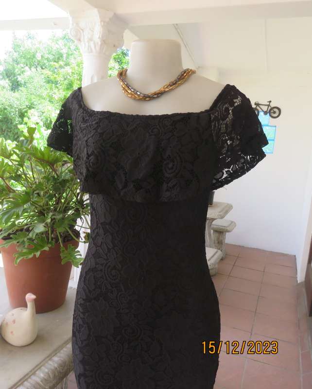 The little black poly/nylon lace dress. Lining stretch poly. Off shoulder/frilled neckline.Size 32