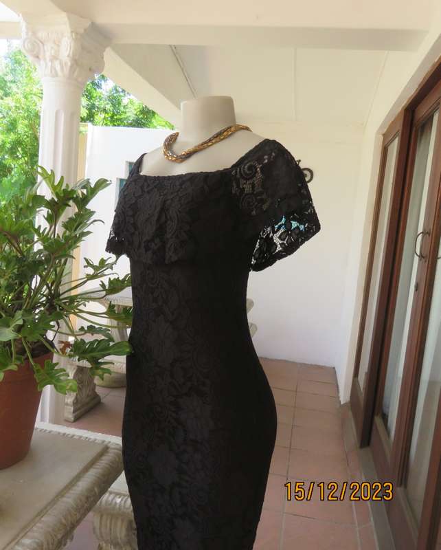 The little black poly/nylon lace dress. Lining stretch poly. Off shoulder/frilled neckline.Size 32