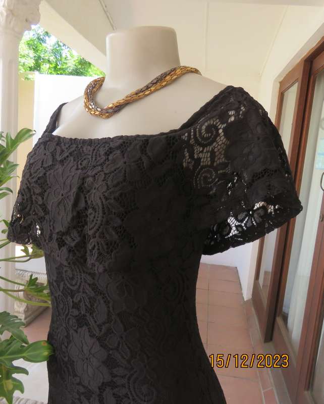 The little black poly/nylon lace dress. Lining stretch poly. Off shoulder/frilled neckline.Size 32