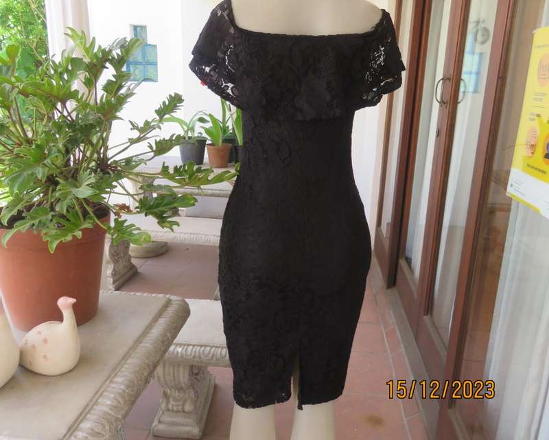 The little black poly/nylon lace dress. Lining stretch poly. Off shoulder/frilled neckline.Size 32