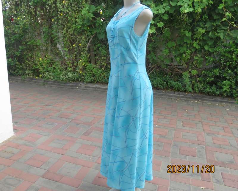 Turquoise maxi a-line dress with empire waist.Size 34/10..In textured polyester.Made by owner.As new