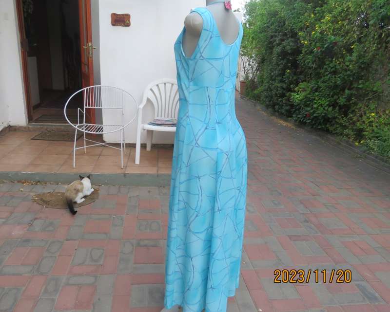 Turquoise maxi a-line dress with empire waist.Size 34/10..In textured polyester.Made by owner.As new