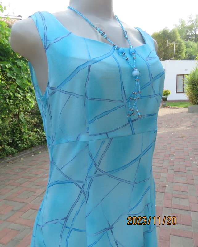 Turquoise maxi a-line dress with empire waist.Size 34/10..In textured polyester.Made by owner.As new