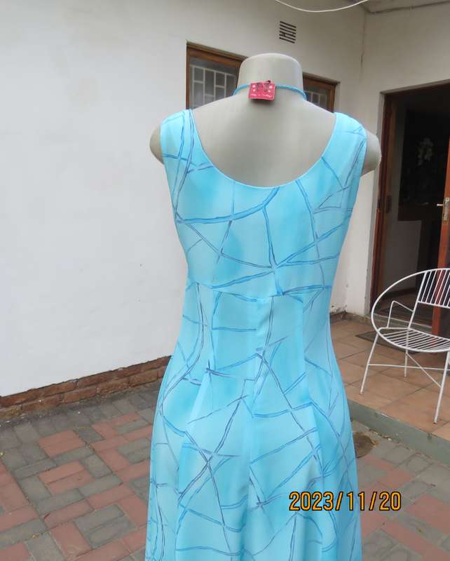 Turquoise maxi a-line dress with empire waist.Size 34/10..In textured polyester.Made by owner.As new