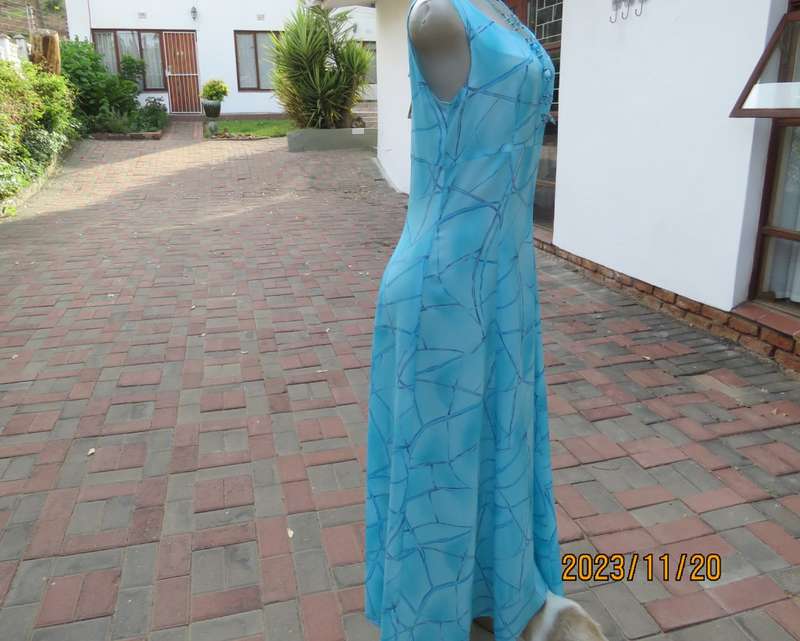 Turquoise maxi a-line dress with empire waist.Size 34/10..In textured polyester.Made by owner.As new