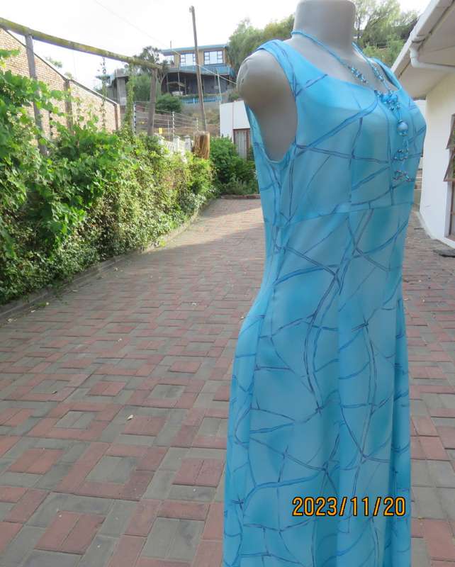 Turquoise maxi a-line dress with empire waist.Size 34/10..In textured polyester.Made by owner.As new