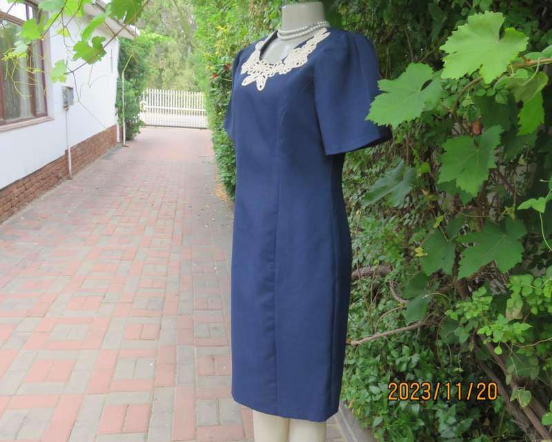 Elegant navy princess style short sleeve boutique made size 36/12 dress with U cream cord floral dec