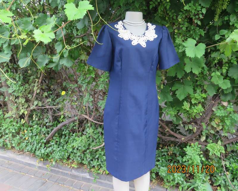 Elegant navy princess style short sleeve boutique made size 36/12 dress with U cream cord floral dec