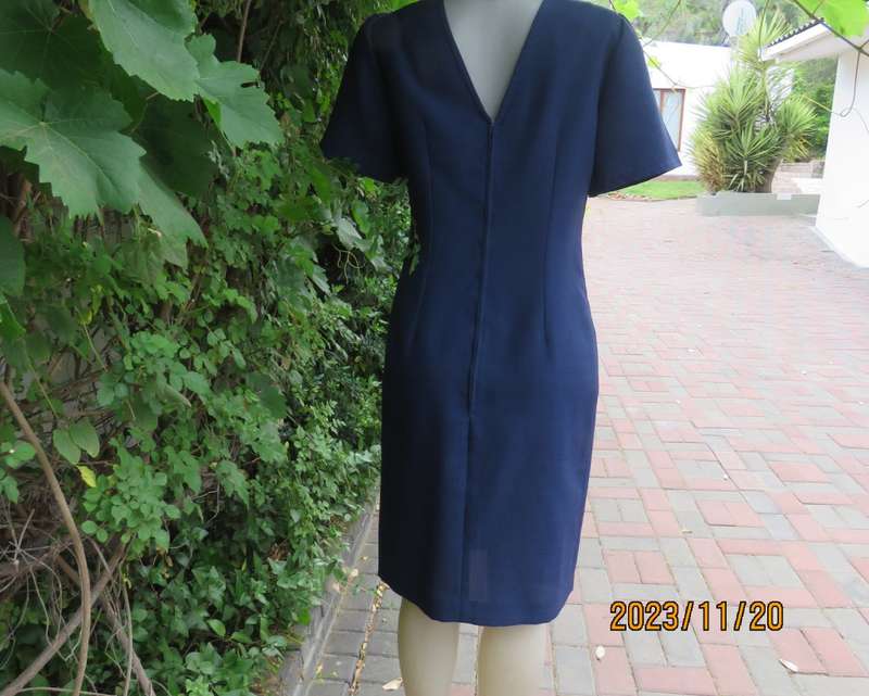 Elegant navy princess style short sleeve boutique made size 36/12 dress with U cream cord floral dec