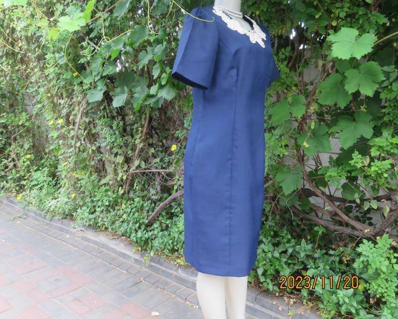 Elegant navy princess style short sleeve boutique made size 36/12 dress with U cream cord floral dec