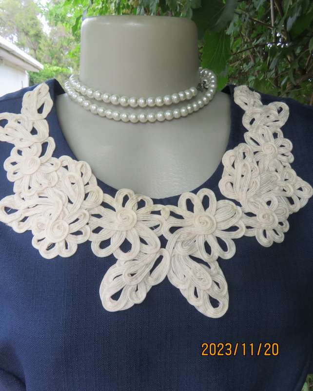 Elegant navy princess style short sleeve boutique made size 36/12 dress with U cream cord floral dec