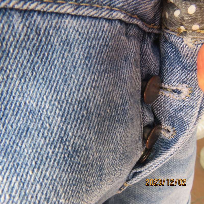 Distressed look denim shorts size 38/14 with turnover legs. Buttoned fly. Pockets back/front.