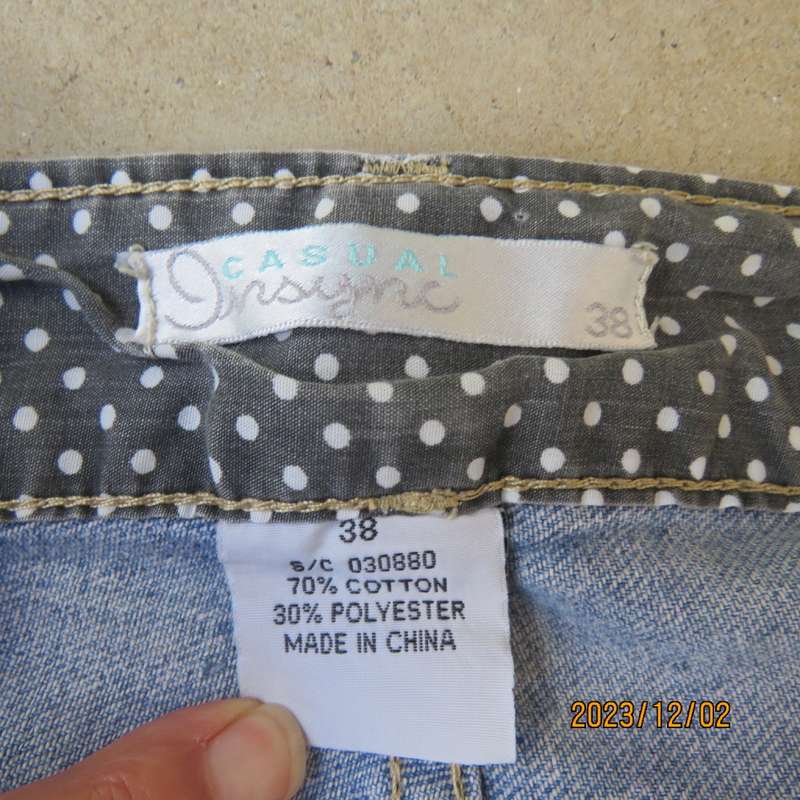 Distressed look denim shorts size 38/14 with turnover legs. Buttoned fly. Pockets back/front.