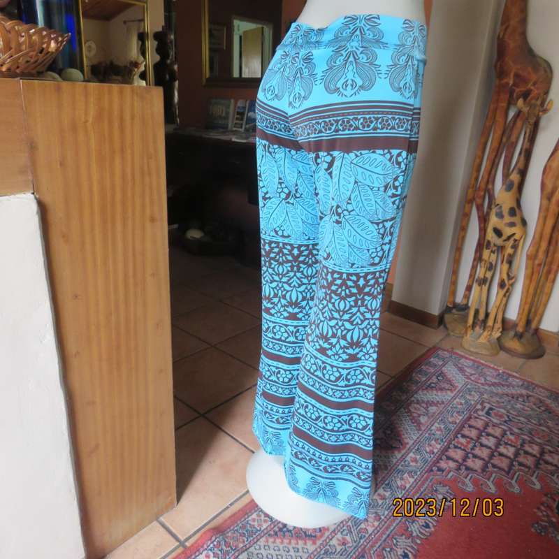 Striking comfy polyester stretch size 36 pants. Turquoise with brown baroque print. Bell bottoms.