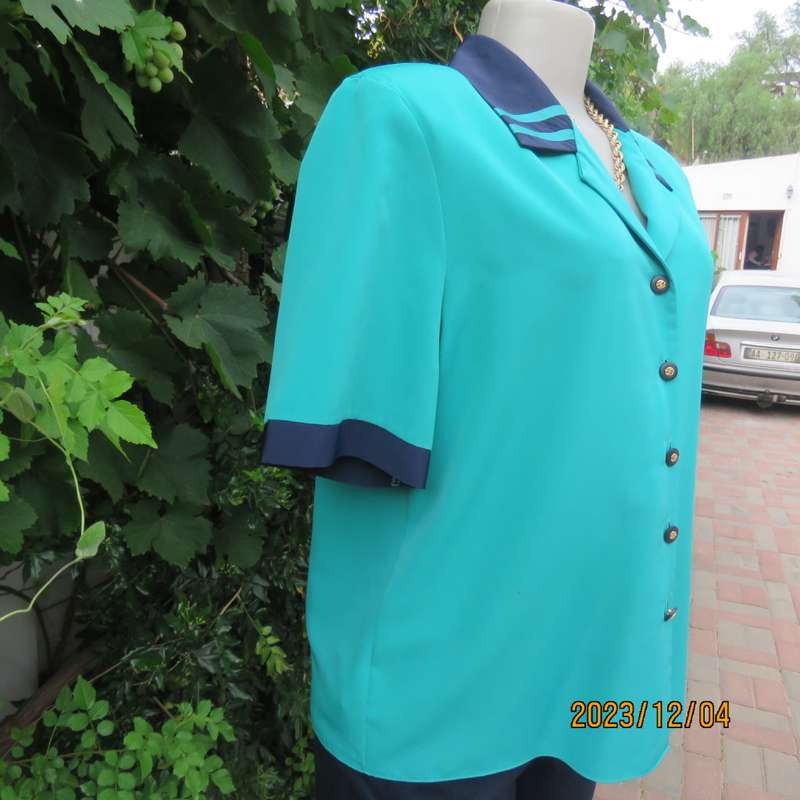 Beautiful jade silky polyester short sleeve top with navy open collar. By WOOLWORTHS size 38. As new